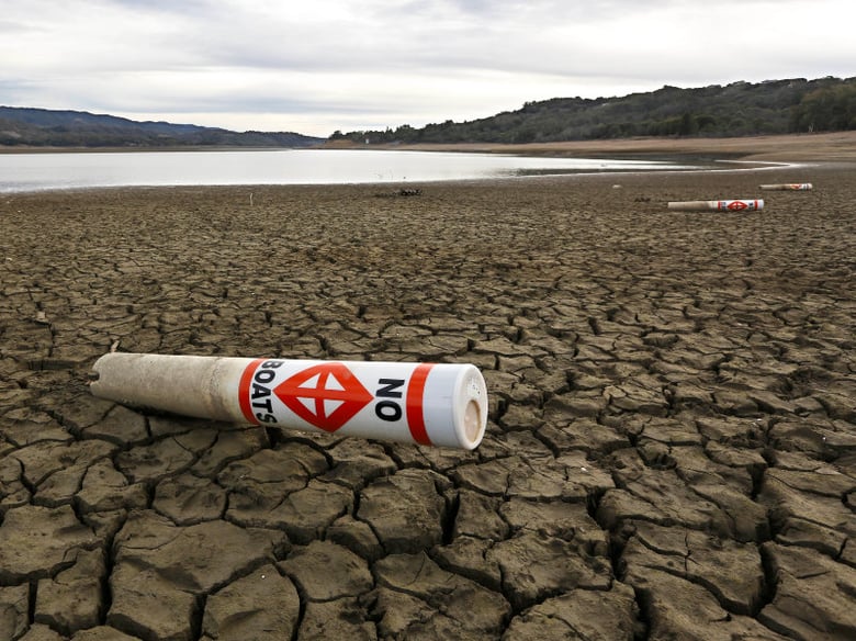 In this Feb. 4, 2014 file photo a warning buoy sits on the dry, cracked bed of Lake Mendocino near Ukiah, Calif. 